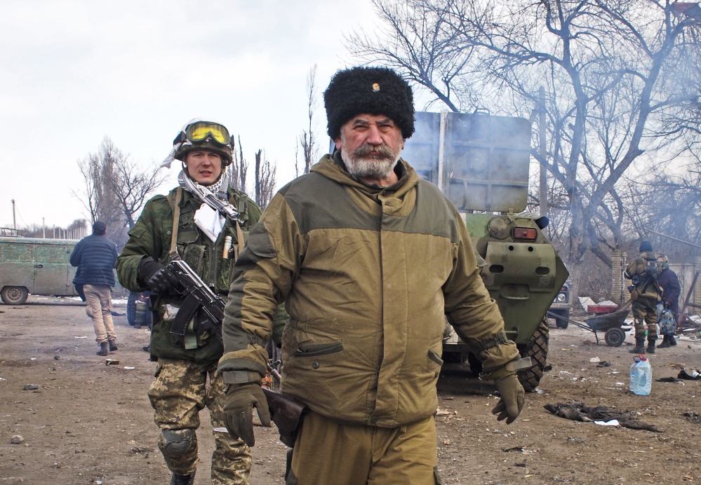 Cossack commander Nikolai Kozitsyn, a Russian national, walks through an area of the contested Ukrainian town of Debaltseve after a rebel victory there Thursday.