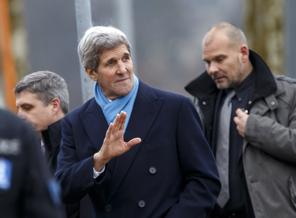 U.S. Secretary of State John Kerry bids farewell to the American delegation after bilateral talks with Iranian officials in Geneva, on Monday. 