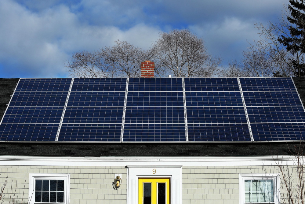 A solar panel array gathers sunlight on the roof of a house on Lynda Road in Portland. In Freeport, 70 residents have signed up to get their properties evaluated and price quotes under a bulk-discount solar panel program.