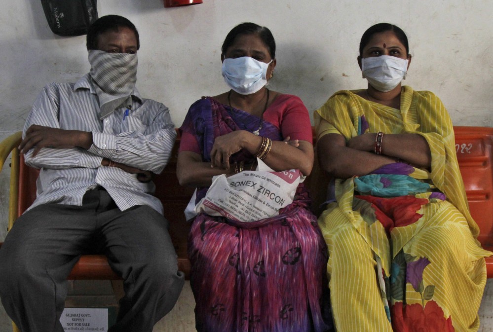 Relatives of swine flu patients sit outside an isolation ward at the Civil Hospital in Ahmadabad, India, on Wednesday.