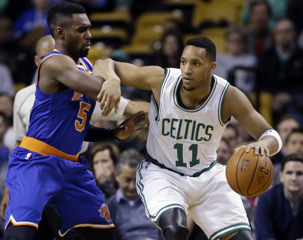 Boston Celtics guard Evan Turner drives against New York Knicks guard Tim Hardaway Jr. during the first half of Wednesday night’s game in Boston. Turner finished with 10 points, 12 rebounds and 10 assists for his first career triple-double.