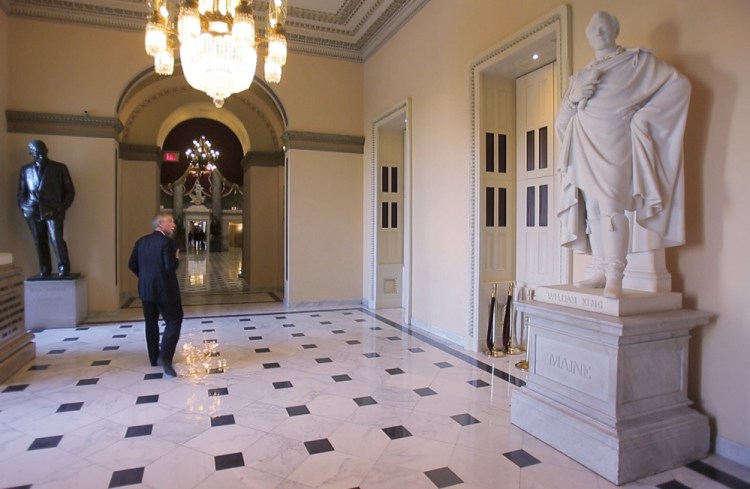 No relation to the 1800s historical figure at right, Sen. Angus King walks past the statue of Gov. William King of Maine in the Capitol. An effort is underway to replace the statue in Washington with one of Gen. Joshua L. Chamberlain.