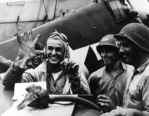 Alex Vraciu signals six kills following his "Turkey Shoot" mission in Great Marianas on June 19, 1944. He downed six dive bombers in eight minutes. U.S. Navy photo