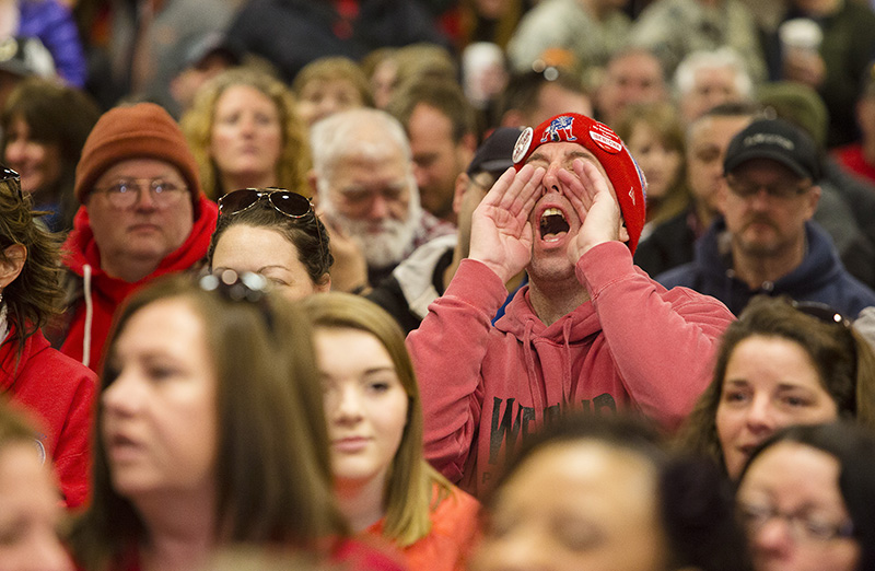 Fairpoint striking employee Kevin Conley shouts, "One day longer, one day stronger" before a meeting to vote on a settlement at the Fireside Inn.