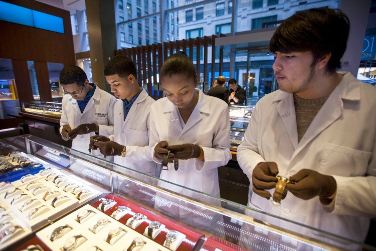 Students from Tourneau's watchmaker program in New York reset watches at the Tourneau store on Madison Avenue on Nov. 1 as Daylight Saving Time wound down in 2014. Clocks in most of the United States will need to be reset again this weekend as Daylight Saving Time begins Sunday at 2 a.m.