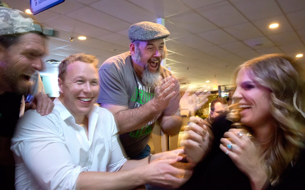 Dan Foley of Gorham, center, celebrates with fellow "Survivor" contestants Mike Holloway of Texas, Tyler Fredrickson of Los Angeles and Sierra Thomas of Utah during Wednesday night's  viewing party at Thatcher's Restaurant & Sports Pub in South Portland.