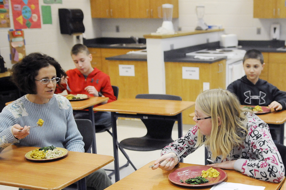 Cony High School teacher Brenda Weis, left, shares a meal her students prepared in the Food Matters program after classes at the Augusta school.