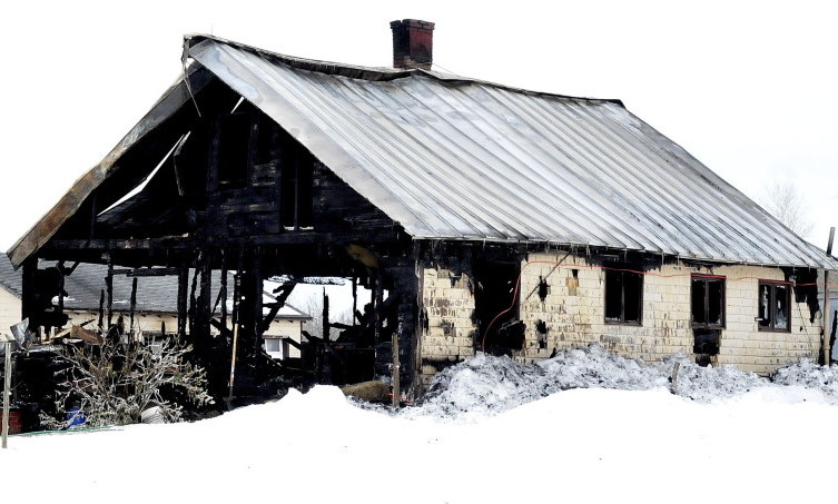 Fire destroyed this old farmhouse on the Weeks Mills Road in New Sharon on Friday, leaving the Tom Bailey family of seven homeless.
