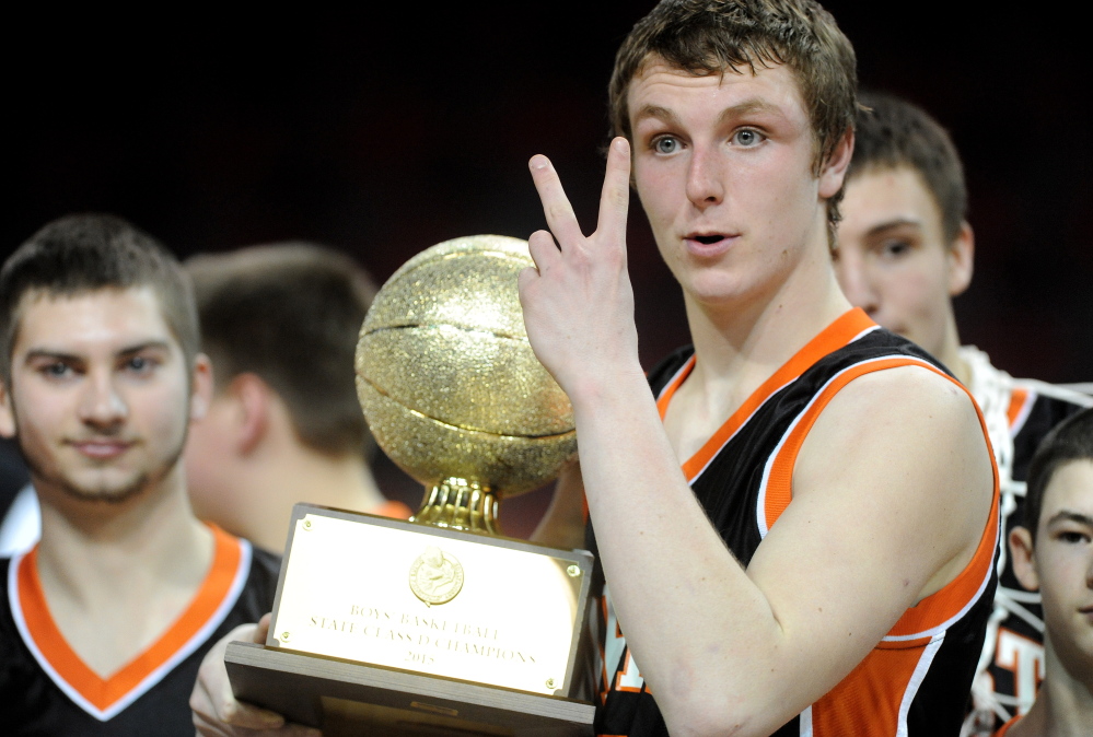 Forest Hills High School’s Ryan Petrin holds up two fingers signaling the two state titles he has won as a member of the basketball team after defeating Fort Fairfield High School 51-45 in the Class D state championship game Saturday at the Cross Insurance Center in Bangor.