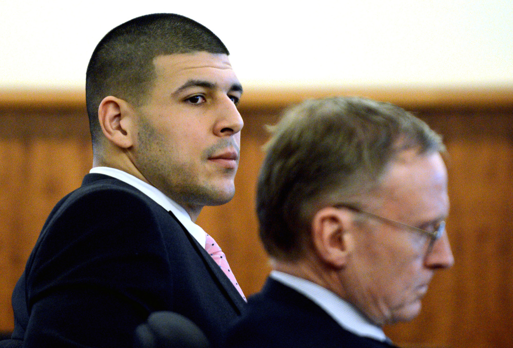 Former New England Patriots NFL football player Aaron Hernandez, left, sits with his attorney Charles Rankin during his murder trial at Bristol County Superior Court on Friday in Fall River, Mass. Hernandez is charged in the murder of Odin Lloyd in 2013.