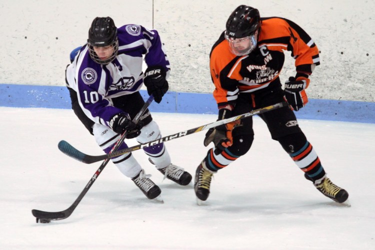 Waterville Senior High School’s Matthew Jolicoeur and Winslow High School’s Alex Berard battle for the puck during first-period action at a Eastern Maine Class B semifinal last week at Sukee Arena in Winslow. The Black Raiders will play Messalonskee on Tuesday night at the Alfond Arena in Orono for the regional championship. The winner of that game moves on to the Class B state championship game Saturday at the Androscoggin Bank Colisee in Lewiston. The last time Winslow won the Class B title was in 2008.