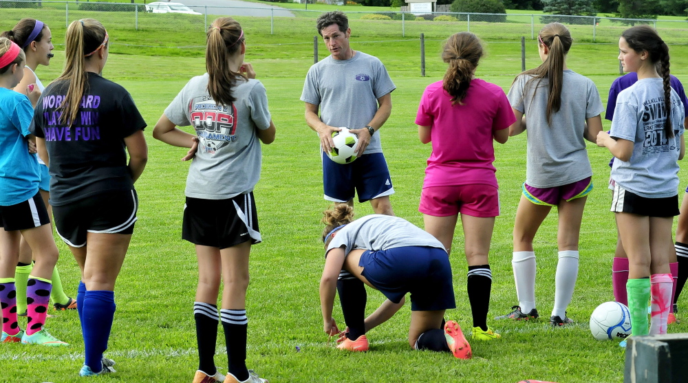 Waterville girls soccer coach Ian Wilson speaks with players during an Aug. 18 practice last year. Wilson told the team Wednesday he is stepping down as coach of the Panthers.