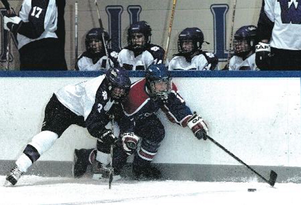 Former Messalonskee forward Ted Fabian gets taken along the boards by Waterville’s Zach Leach during a December 2005 game at Colby College. Fabian won the Travis Roy Award in 2006 and is now the head coach at Lawrence/Skowhegan.