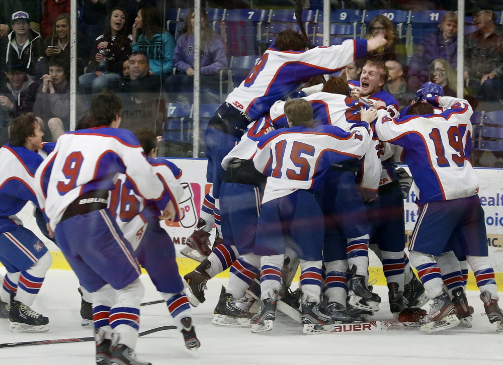 Members of the Messalonskee celebrate after they defeated Gorham 6-1 in the Class B state title game last March in Lewiston. The program is celebrating its 20th season with a return trip to states.