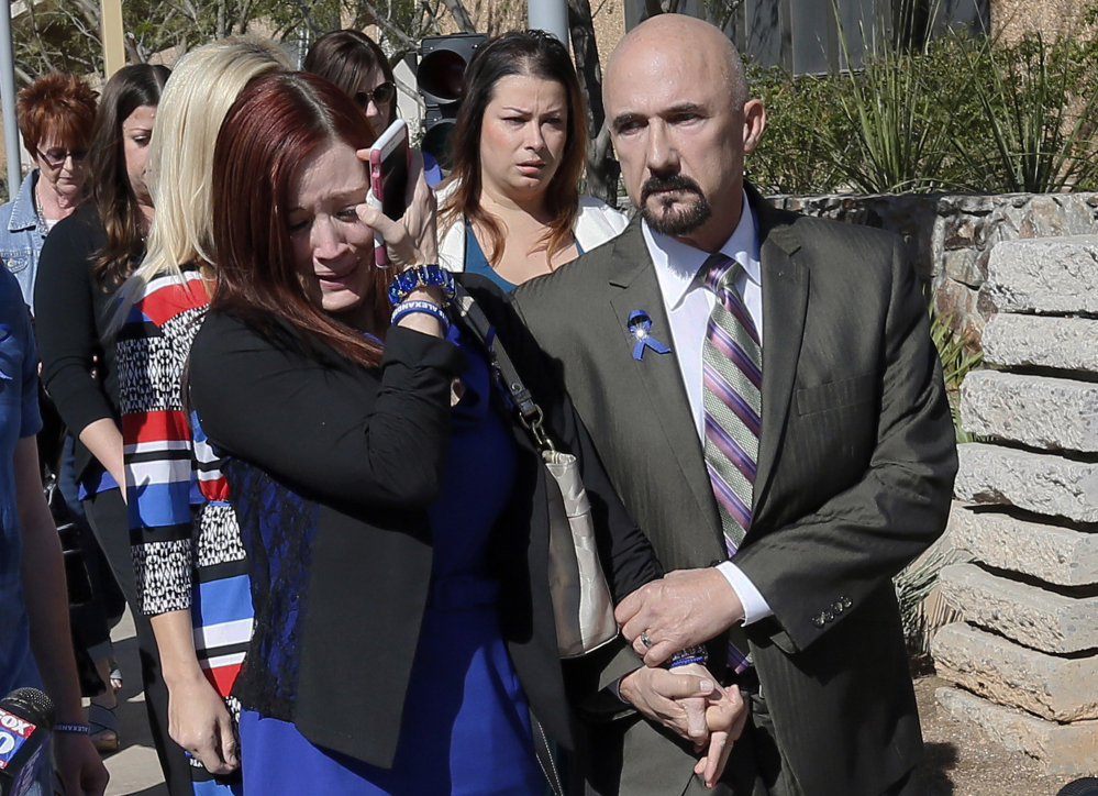 Tanisha Sorenson, sister of murder victim Travis Alexander, cries as she leaves the courthouse with family and friends Thursday in Phoenix.