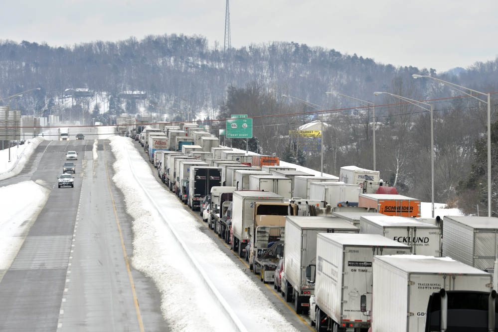Traffic backs up as more than 50 miles of Interstate 65 southbound is shut down because of the weather on Thursday near Mount Washington, Ky. Kentucky State Police reported that the interstate will not reopen until Thursday evening.