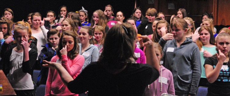 Conductor Nora Krainis leads the sixth grade honors chorus in warmups at the start of rehearsal on Friday at Gardiner Area High School. There were about 230 music students from 30 central Maine schools at the day-long District III Sixth Grade Honors Festival.
