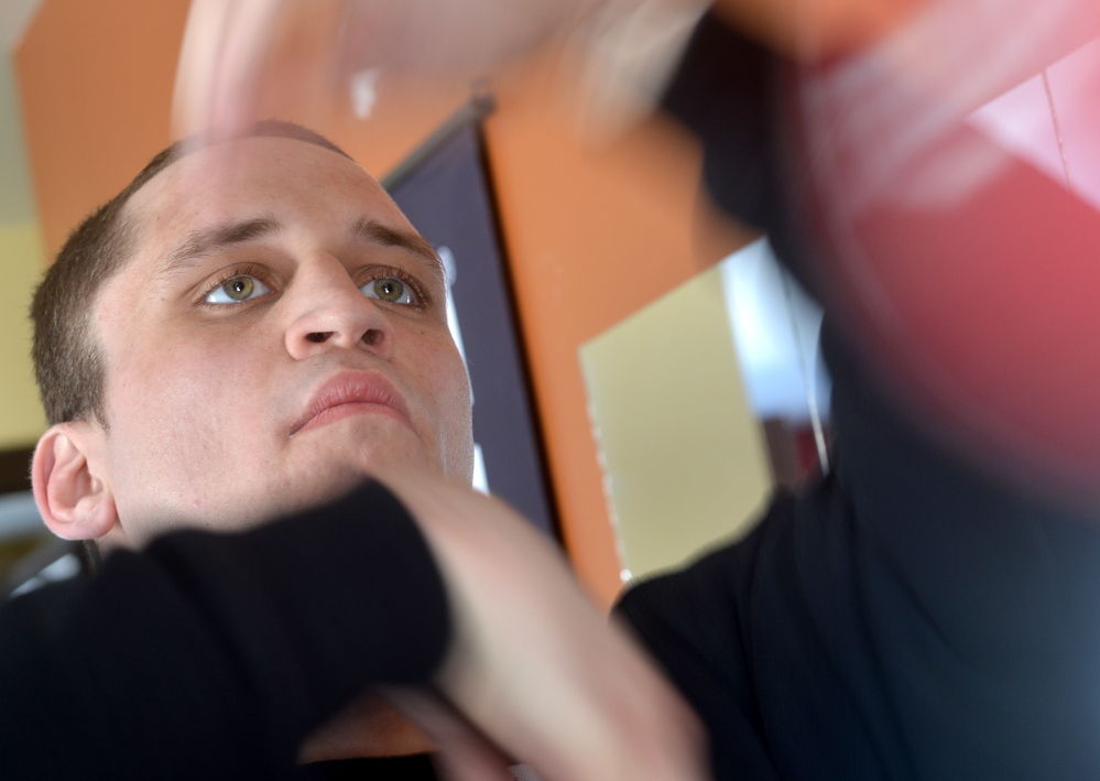 Justin Rolfe, of Fairfield, works out in his home gym.