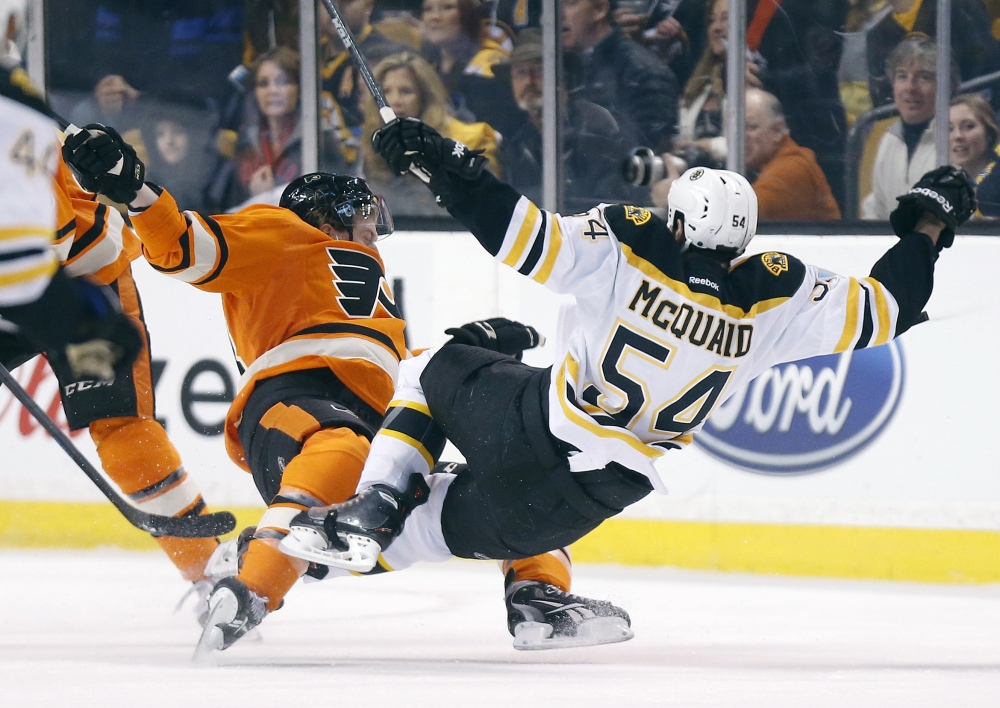 Brayden Schenn, left, of the Flyers collides with Boston’s Adam McQuaid in the first period Saturday in Boston.