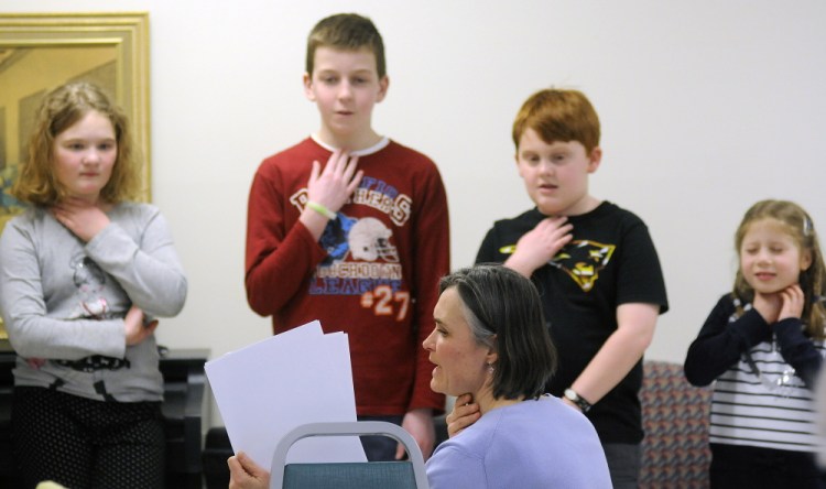 Karen Foust, the teacher for the Maine French Language Heritage Program, leads Augusta elementary school students enrolled in the French language program in a song Tuesday at the Chateau Cushnoc in Augusta.