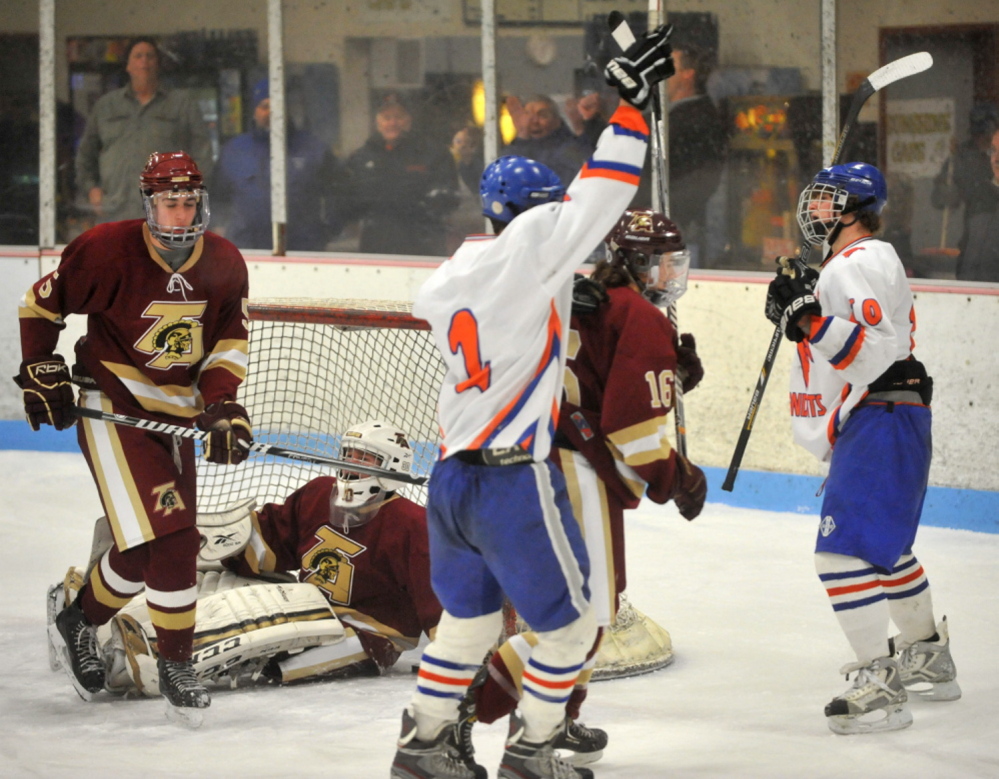 Lawrence/Skowhegan senior forward Cody Martin, right, celebrates with Andrew Carpenter, center, during a game against Thornton Academy this season. Martin was named a Travis Roy Award finalisr on Monday.