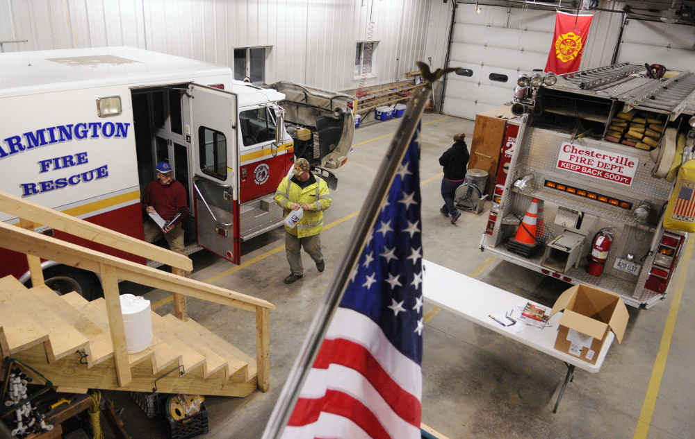 Chesterville firefighters inspect one of the department’s fire rescue trucks recently at the fire station in Chesterville. Central Maine departments are feeling the crunch of fewer volunteers, less money and more required training.