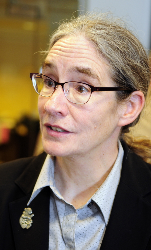 Jaye Martin, executive director of Legal Services for the Elderly, answers questions after the Financial Crimes Against the Elderly news conference on Wednesday at the State House.