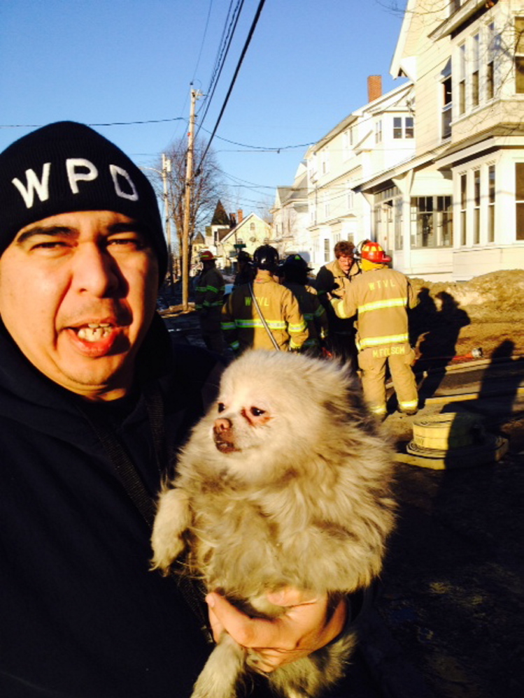 Waterville Animal Control Officer Chris Martinez retrieves a dog named Sugar that firefighters rescued from a first floor apartment at 58 Silver St. in Waterville during a fire  early Thursday evening. Martinez said late Thursday that he took the dog to Kennebec Valley Veterinary Services in Oakland where it was treated for smoke inhalation and given a bath. The owner of the dog was in the hospital at the time the fire broke out and the dog was alone in her apartment, where the fire started. The dog, a female, is staying with a friend if its owner, Martinez said.