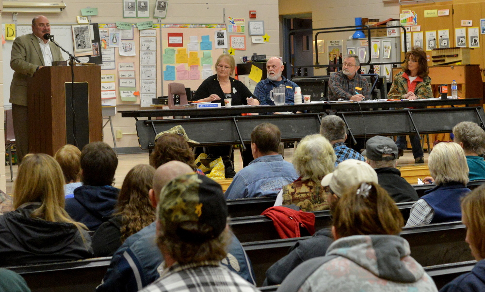Susan Anneley, town clerk, left, and select board members Maynard Webster, Forrest Bonney and Lorna Nichols, far right, sit at the table during the annual town meeting at the New Sharon Elementary School on Saturday, March 7. Bonney said he would resign after Webster was not re-elected.