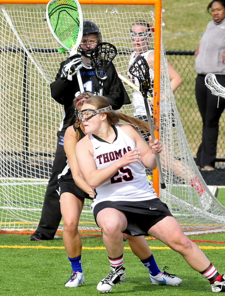 Thomas College player Jennifer Day (25) evades pressure from Colby-Sawyer players near the goal during a game last season.