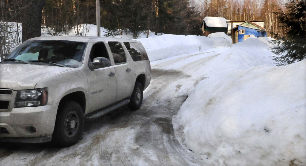 A Maine State Police trooper sits in a cruiser at the end of the driveway at 188 Rutland Road in Troy on March 8 after the body of Steven Hodgdon was discovered at the home early the previous morning.