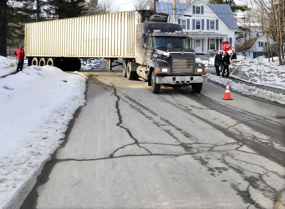 A 50-foot tractor-trailer turns from Perham Street onto Quebec Street in Farmington past Planning Board members to test if the rig can make deliveries of wood chips to a proposed wood boiler system on the University of Maine campus on Monday. The rig appeared to have no problem with the turn.