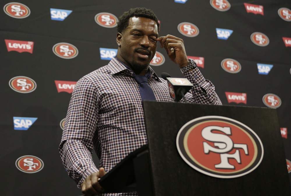 San Francisco 49ers linebacker Patrick Willis wipes his eye as he speaks at a news conference at the team’s NFL football facility in Santa Clara, Tuesday.