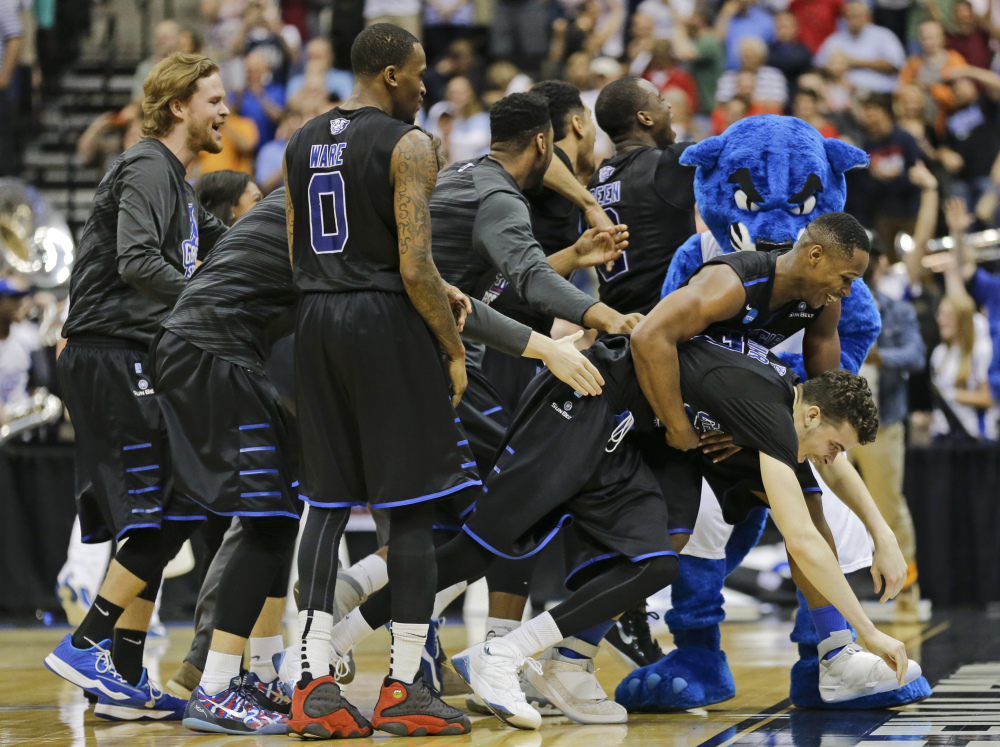 Georgia State players celebrate as they surround R.J. Hunter, right, after he made the game-winning shot against Baylor late in the second half Thursday in the second round of the NCAA tournament in Jacksonville, Fla. Georgia State won 57-56.
