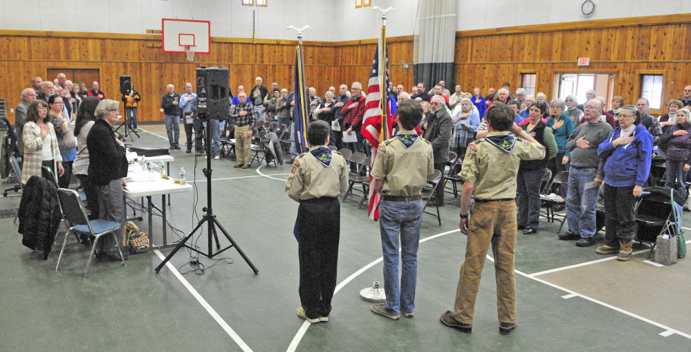 Boy Scouts from Troop 453 present the colors and lead the Pledge of Allegiance on Saturday to start the Belgrade Town Meeting at the Center For All Seasons in Belgrade.