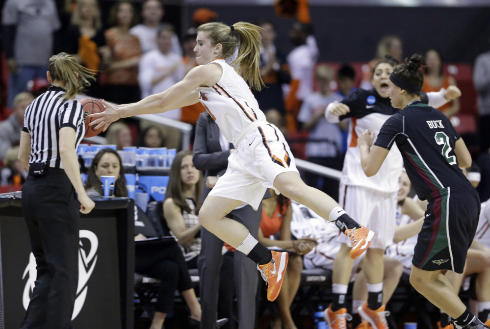 Princeton guard Blake Dietrick, center, tries to keep a ball in bounds in front of Green Bay guard Tesha Buck, right, in the first half of Saturday’s first round of the NCAA women’s tournament at College Park, Md.