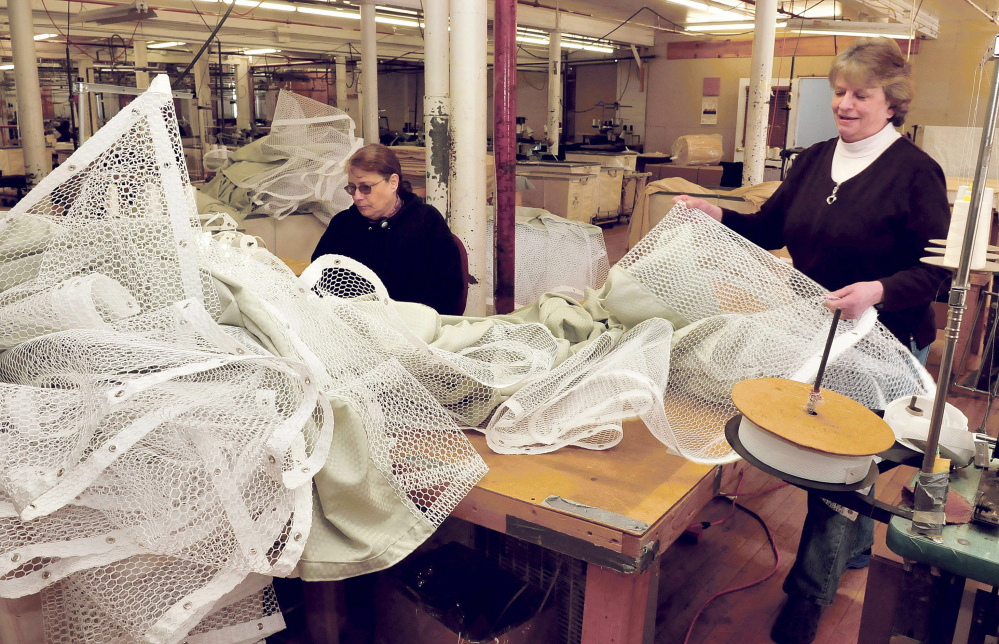 Maine Stitching Specialties employees Beth Moulton, left, and Cindy Laney work on medical privacy curtains made at the Skowhegan company.