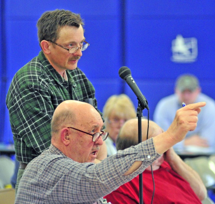 TIm Lawrence, top, and Robert Bender participate in the debate Saturday during the Pittston Town Meeting at the Pittston Consolidated School.