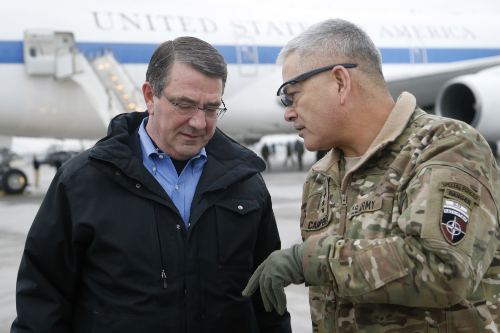 In this Feb. 21, 2015, file photo, U.S. Secretary of Defense Ash Carter, left, walks with U.S. Army Gen. John Campbell upon arrival at Hamid Karzai International Airport in Kabul, Afghanistan.