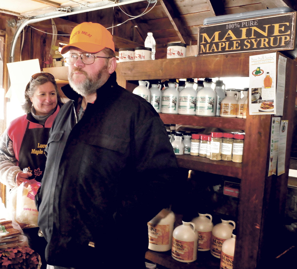 Arnold Luce speaks on Sunday about this year’s Maine Maple Sunday event and his family’s long history of making syrup as his wife, Elaine, restocks shelves with maple products at the Luce family farm in Anson.