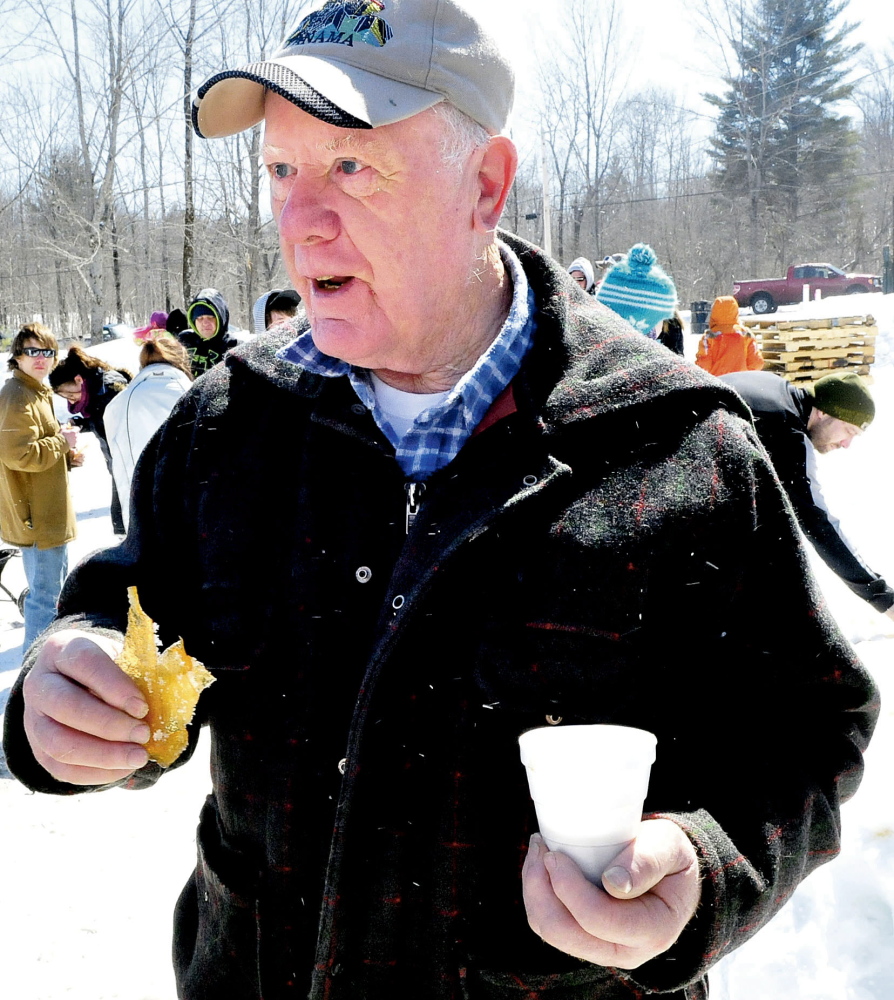 Holding a piece of homemade maple syrup candy, Roger Barber, of Clinton, talks on Sunday about his appreciation for visiting maple operations such as this one at Strawberry Hill in Skowhegan during Maine Maple Sunday.