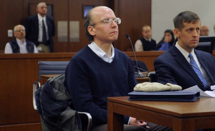 Christopher Knight, center, sat silently Monday during his graduation from the Co-Ocurring Disorders Court Program in Augusta.  Known as the North Pond Hermit, Knight spent seven months in jail and followed by 17 months in the special court program.