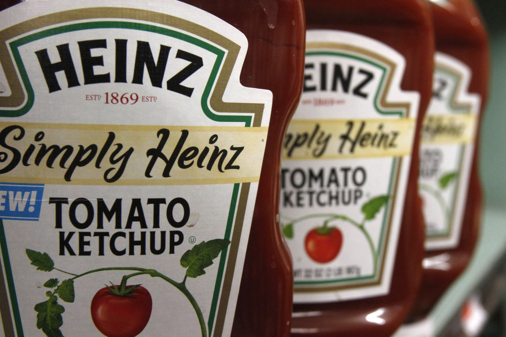 This Wednesday, March 2, 2011, file photo, shows containers of Heinz ketchup on the shelf of a market, in Barre, Vt. H.J. Heinz Co. is buying Kraft Foods Group Inc., creating what the companies say will be the third-largest food and beverage company in North America, the companies announced Wednesday.
