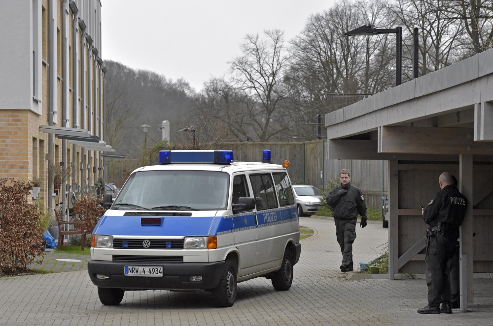 Police officers block a street where the co-pilot of the crashed Germanwings airliner jet is supposed to have lived lived in an apartment, in Duesseldorf, Germany, Thursday in connection with investigations of the crash of the aircraft in the French Alps on Tuesday, which killed 150 people. The co-pilot of the doomed Germanwings jet barricaded himself in the cockpit and “intentionally” sent the plane full speed into a mountain in the French Alps, ignoring the pilot’s frantic pounding on the door and the screams of terror from passengers, a prosecutor said Thursday.