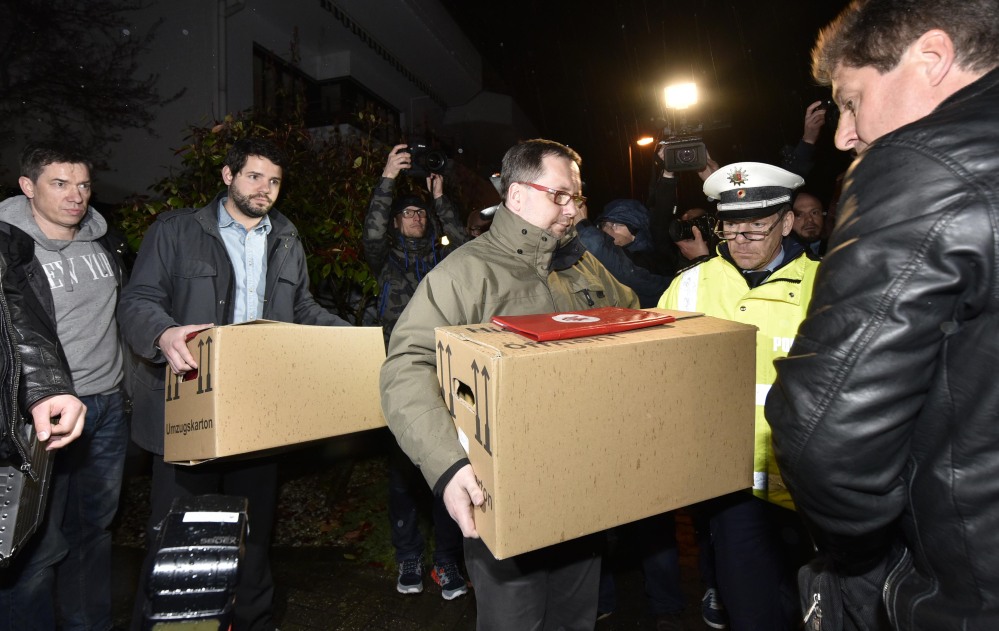 Investigators carry boxes from the apartment of Germanwings co-pilot Andreas Lubitz on Thursday in Duesseldorf, Germany. French prosecutors said Lubitz “intentionally” crashed Flight 9525 into the side of a mountain Tuesday in the French Alps.