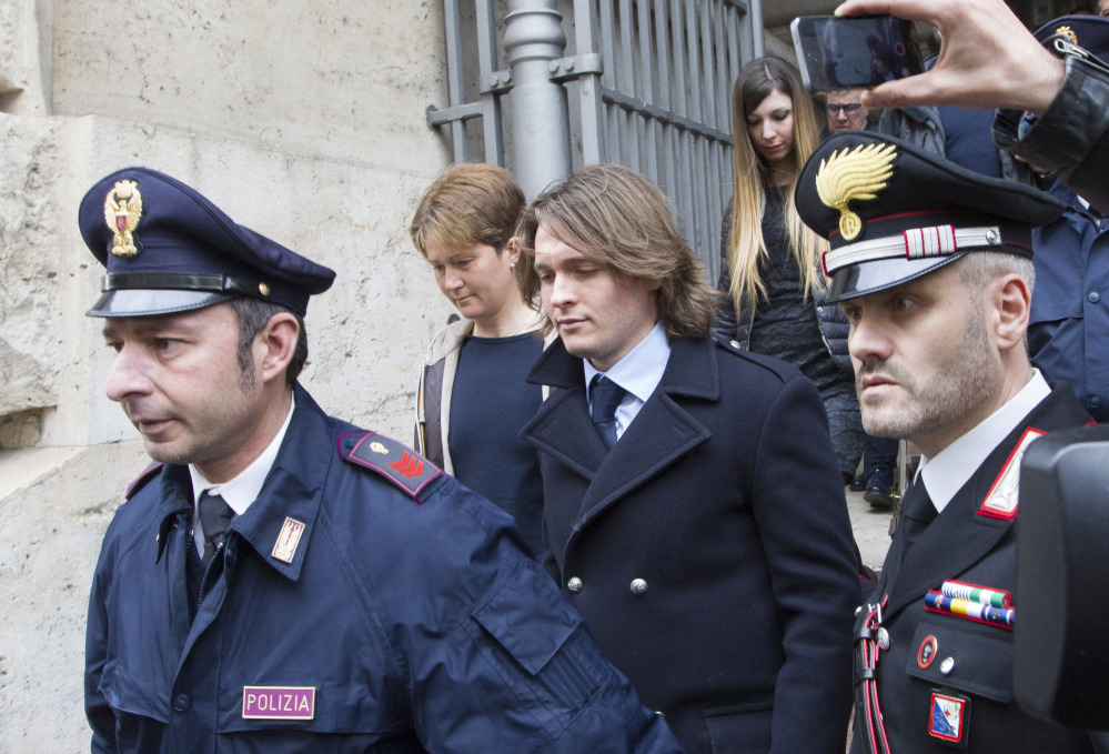 Raffaele Sollecito, center, leaves Italy’s highest court building with his girlfriend, Greta Menegaldo, in Rome on Friday. He and Amanda Knox expect to learn their fate when Italy’s highest court hears their appeal of their guilty verdicts in the brutal 2007 murder of Knox’s British roommate Meredith Kercher.