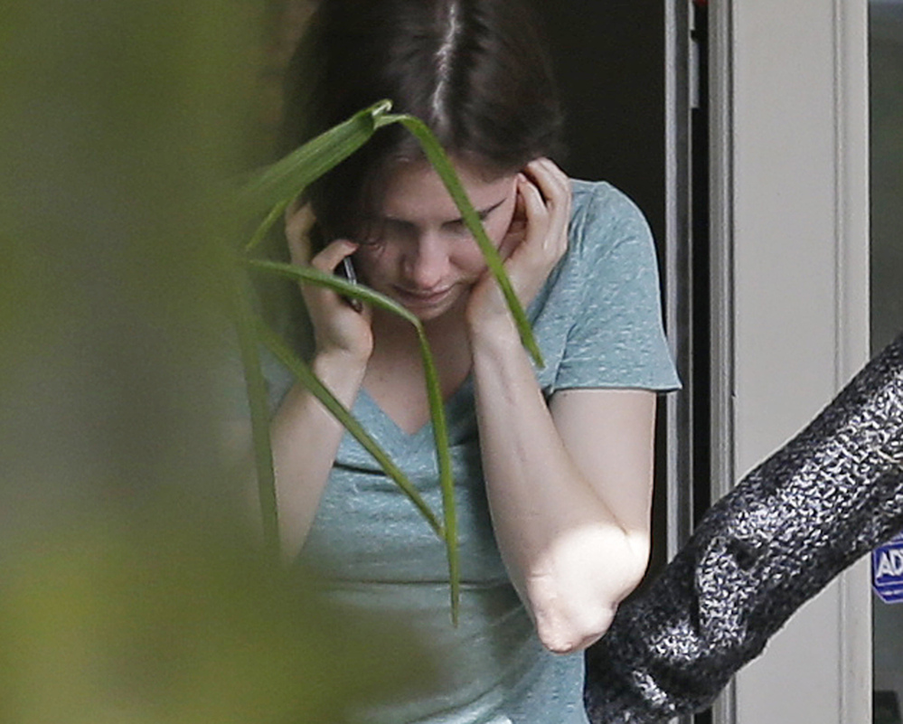Amanda Knox talks on a phone Friday in the backyard of her mother’s house in Seattle. Italy’s highest court overturned the murder conviction against Knox and her ex-boyfriend Friday in the 2007 slaying of Knox’s roommate, ending the high-profile case.