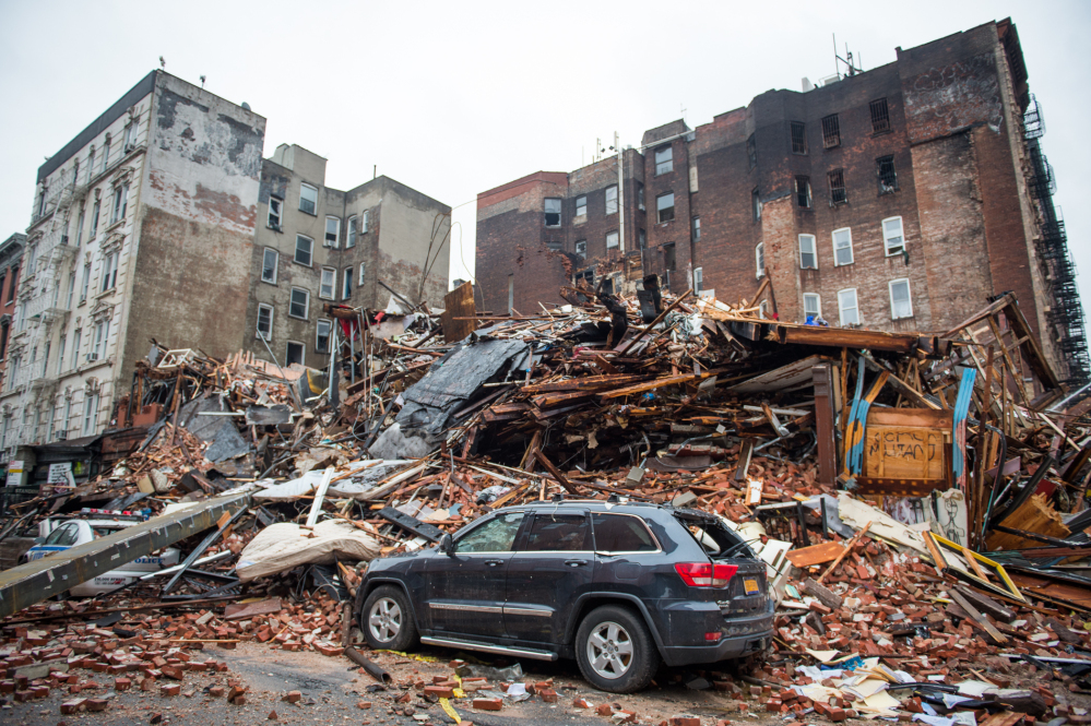 A pile of debris remains Friday at the site of a building explosion in New York. Mayor Bill de Blasio said someone may have improperly tapped a gas line before Thursday’s explosion.