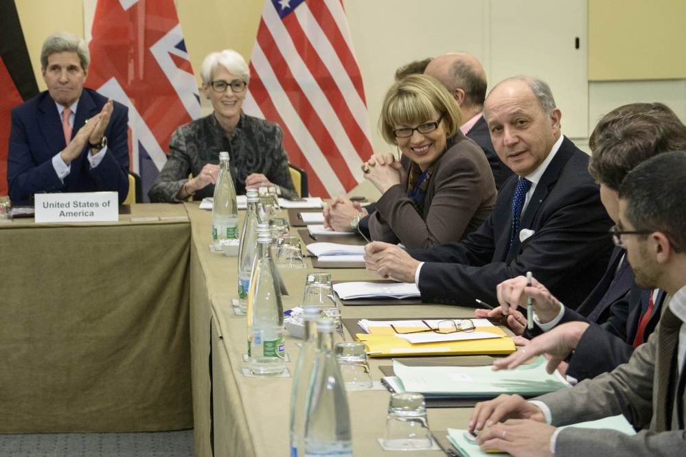 US Secretary of State, John Kerry, left, US Under Secretary for Political Affairs, Wendy Sherman, 2nd left, French Foreign Minister, Laurent Fabius, right, and others wait for the start of a trilateral meeting at an hotel in Lausanne Saturday.
