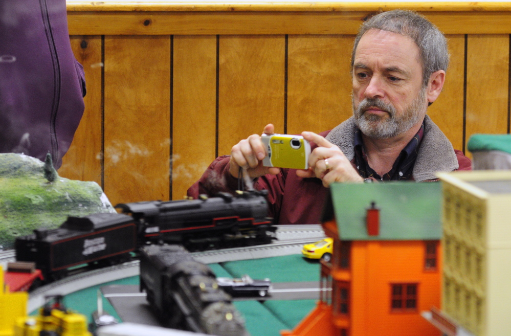 Earl Pollock takes a photo of an engine at the Maine3Railers model railroad show on Saturday at the Elks Club in Augusta.